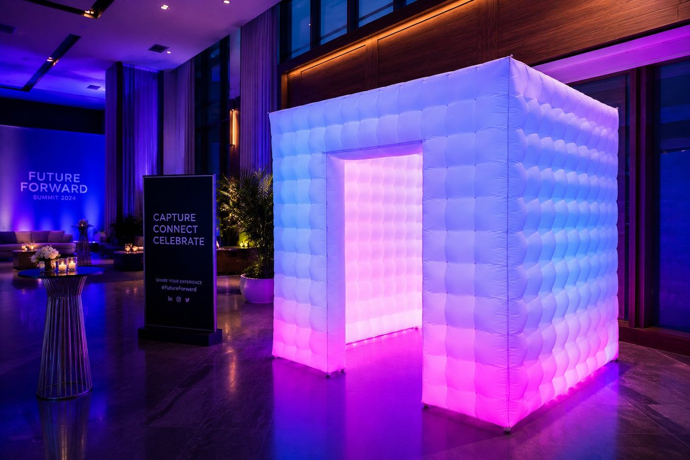 FaceBooth white LED photo booth at a corporate event with blue and pink lighting