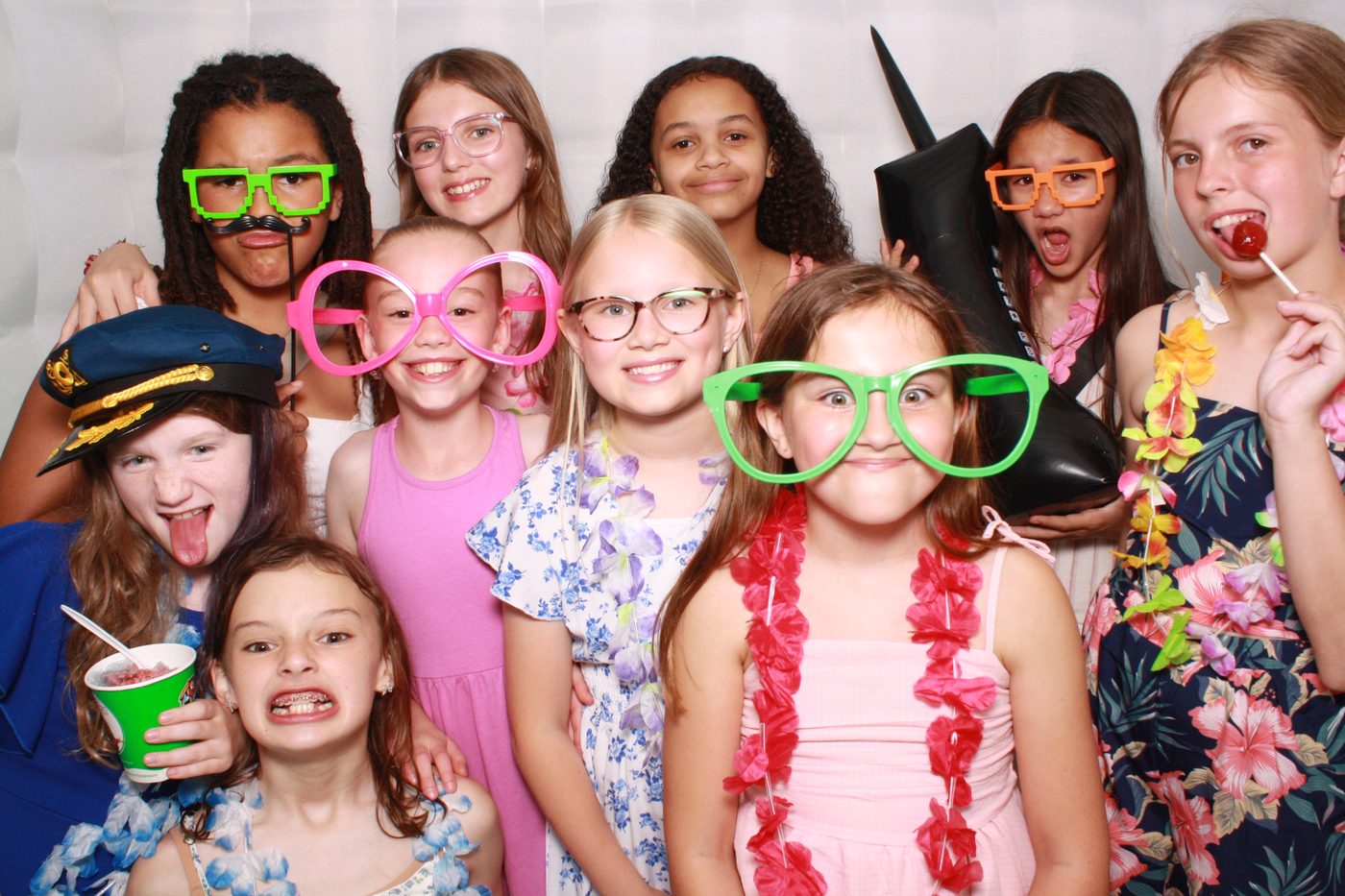 Kids with props in the FaceBooth photo booth at a birthday party