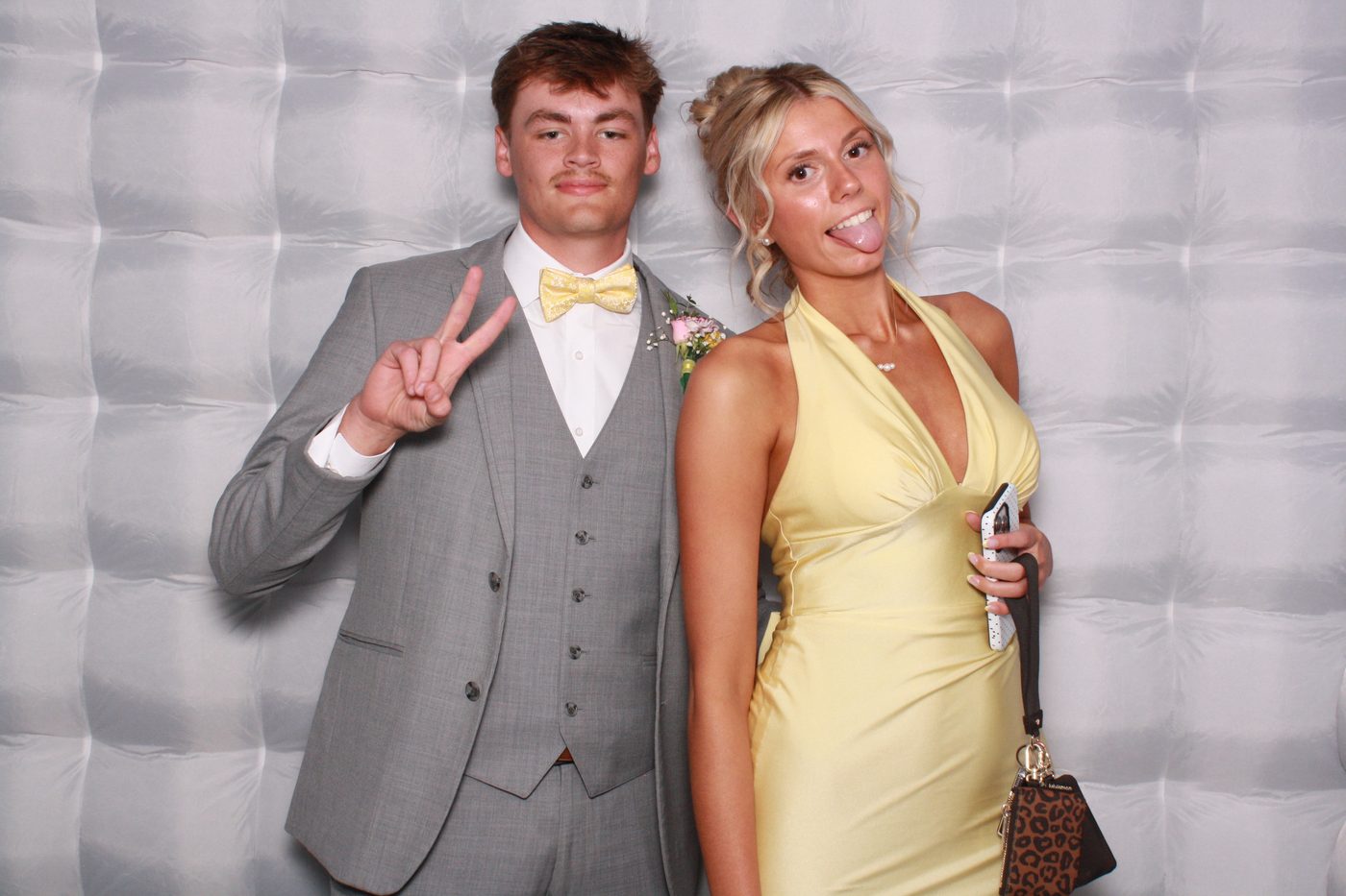 Prom couple in formal wear at the photo booth